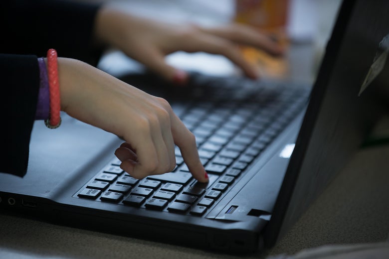 Person typing on a laptop.